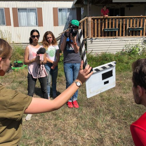 youth at camp, with film camera, slate, and mic